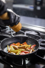Chef grinding salt into a pan
