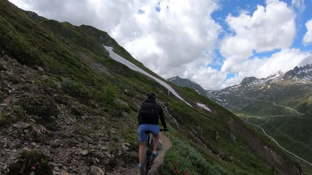Two Mountain Bikers Riding an Exposed Alpine Trail to Corno Gries Hut, Val Formazza, Italy