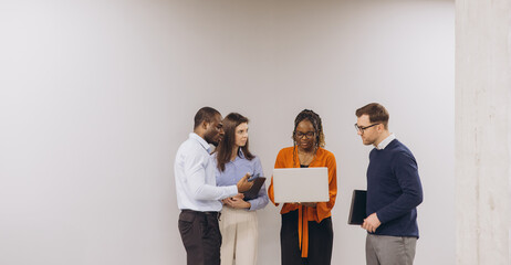 Diverse group of business professionals engaging in a collaborative discussion, focused on a...