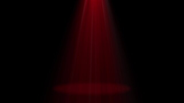 One Red Top Spot Bright Light illuminating a studio stage on a black background