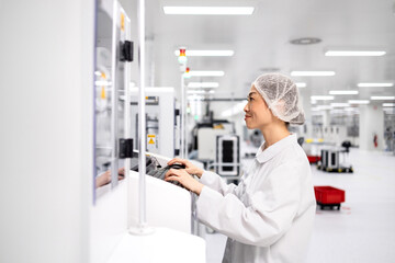 Japanese scientist operating industrial machine in research and development factory.