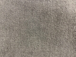 Close-up of gray fabric texture with diagonal weave pattern.