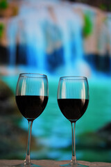 Two glasses of red wine in close-up on a beautiful turquoise background.