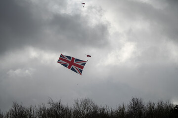 Red Devil's parachutist display team member descends with a huge union flag in tow