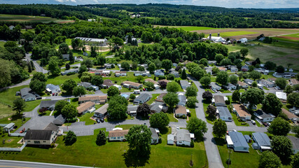 Aerial view of a tranquil rural community featuring various Mobile, Prefab, Manufactured houses...