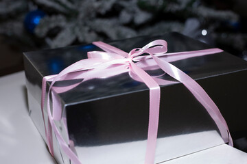 Gift box near Christmas tree  close up