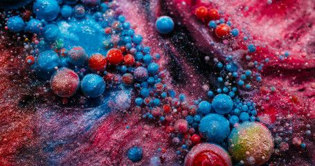 Shimmering flow. Paint glitter drop. Colorful acrylic blue pink gel dissolving in sparkling powder...