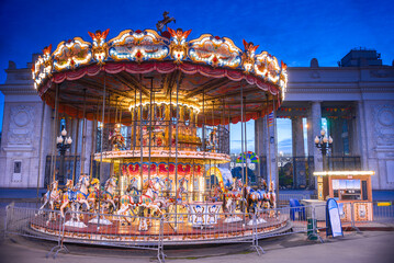Evening view of the horse riding carousel, at the entrance to the park. Moscow, Russia