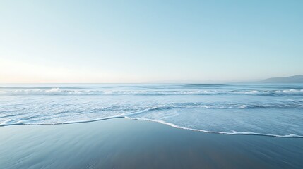 Obraz premium Serene Ocean Waves Gently Reaching Sandy Shore