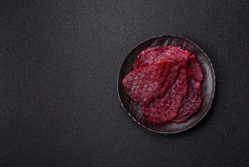 Dried beef slices, jerky, with cherry or plum flavor, salt and spices