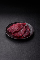 Dried beef slices, jerky, with cherry or plum flavor, salt and spices