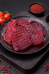 Dried beef slices, jerky, with cherry or plum flavor, salt and spices