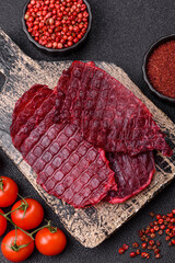 Dried beef slices, jerky, with cherry or plum flavor, salt and spices