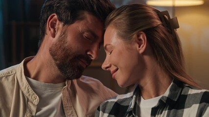 Happy Caucasian romantic couple cuddling foreheads touch smiling feel affection love romance moment at home night tender relationship loving man woman faces girl guy lovers family newlyweds wedding