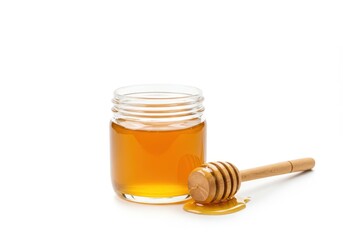 A small glass jar filled with golden honey accompanied by a wooden honey dripper with dripping honey isolated on white background
