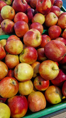 Apples for sale in a supermarket. Ripe juicy apples close-up with selective focus. Fruits. A pile of apples for sale in a store. A variety of fresh apples on a supermarket counter