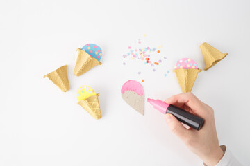 A creative and colorful arrangement of craft materials including cone shapes and colorful paper. A great visual for businesses related to crafting, party decorations, or creative workshops for kids