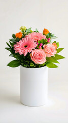 Fototapeta premium A white vase filled with pink and orange flowers on a white table