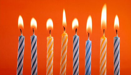 satisfied birthday lit candles on orange background