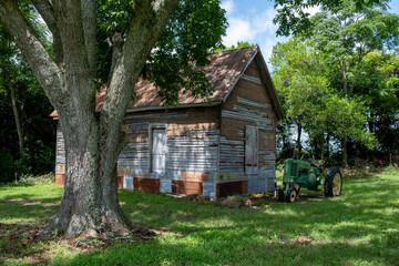old wooden house and farm tractor