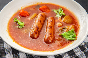 Tomato soup with sausages fresh tasty food dish delicious gourmet food background on the table rustic food top view copy space