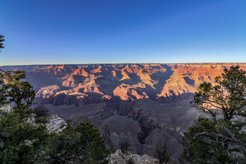 The breathtaking and stunning view of the rugged canyon landscape shines under a clear blue sky, Grand Canyon, USA