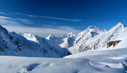 snowy mountain landscape beneath a blue sky
