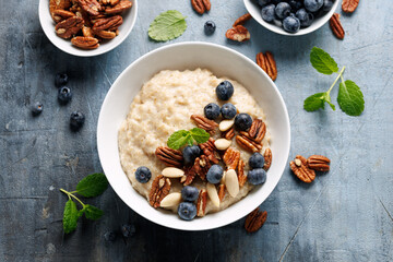 Oatmeal porridge with blueberry, almonds, and pecan healthy food breakfast.