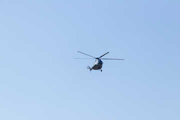 Helicopter MI-8 Flying Against a Clear Blue Sky with Minimalist Background.dng