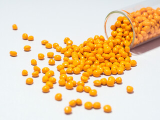 Turmeric yellow masterbatch granules isolated on white background,color pigment carrier polymer in plastic industry.Perfect for plastic company catalog design