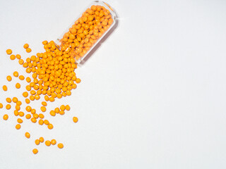 Turmeric yellow masterbatch granules isolated on white background,color pigment carrier polymer in...