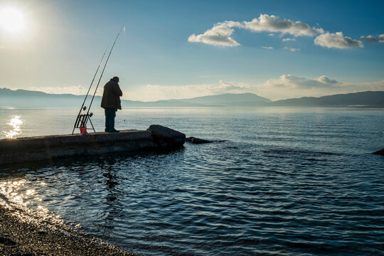 Fisherman on a pier near Elefsina Bay, Greece