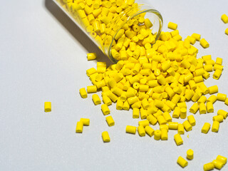 Yellow masterbatch granules isolated on white background,color pigment carrier polymer in plastic...
