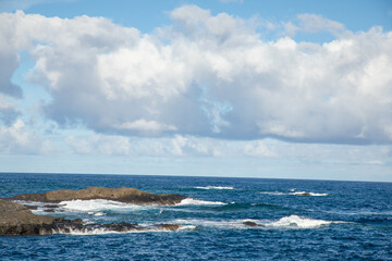 Fototapeta premium Sea foam and Atlantic Ocean waves crashing against rocks