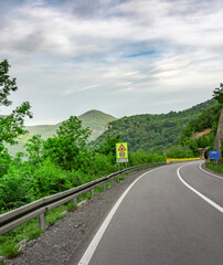 Road with a yellow sign that says 