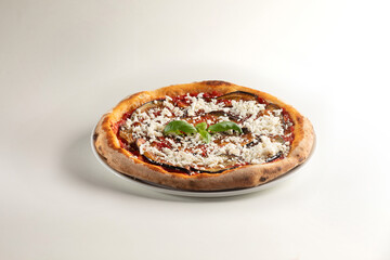 delicious pizza with ricotta salata, eggplant, and basil on white background