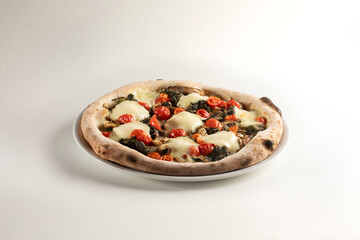 delicious vegetarian pizza made with tomatoes cheese, vegetables on white background - plate