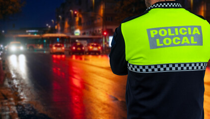 Local Police officer at a night traffic alcohol and drug checkpoint in a city in Spain.