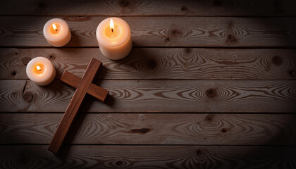 Candles burning beside wooden cross on rustic table, Maundy Thursday