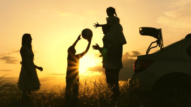 family ball game sunset by car. travel child parents car. people nature. fun child fun with mother father park. air ball flies air. child throws ball sunset dad mom. happy children with parents park