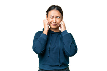 Young Uruguayan woman over isolated chroma key background frustrated and covering ears
