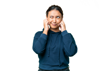 Young Uruguayan woman over isolated chroma key background frustrated and covering ears