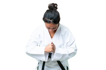 Young Uruguayan woman over isolated chroma key background doing karate and saluting