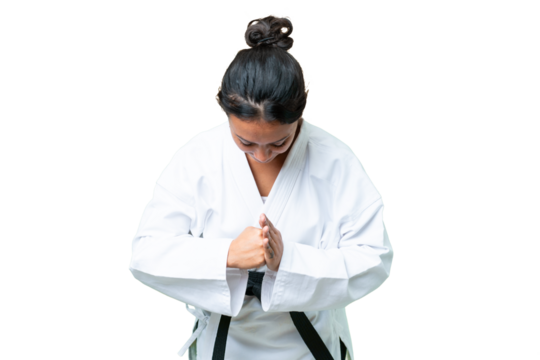 Young Uruguayan woman over isolated chroma key background doing karate and saluting