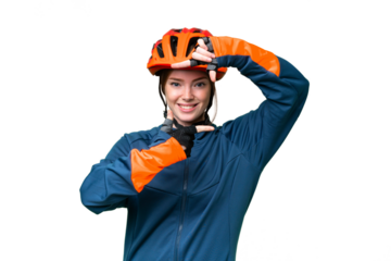 Young cyclist woman over isolated chroma key background focusing face. Framing symbol