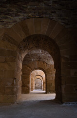 Series of arched stone passageways in a medieval fortress, photographed with linear perspective.
