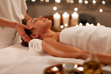 Masseuse making relaxing head massage for woman, lady getting healing head massage at luxury spa in...