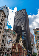 A view up State Street of old and new buildings in Boston in the fall