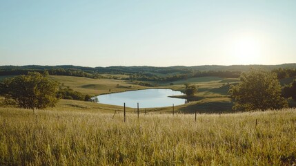Serene sunset over rural pond, grassy hills