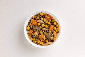 A top view of a round white bowl filled with summer vegetable salad, set against a white background. Simple, clean design, perfect for food styling, product mockups, or promotional use.